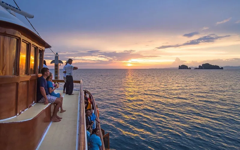 Guests watching sunset from the M/Y Lalida deck in Krabi