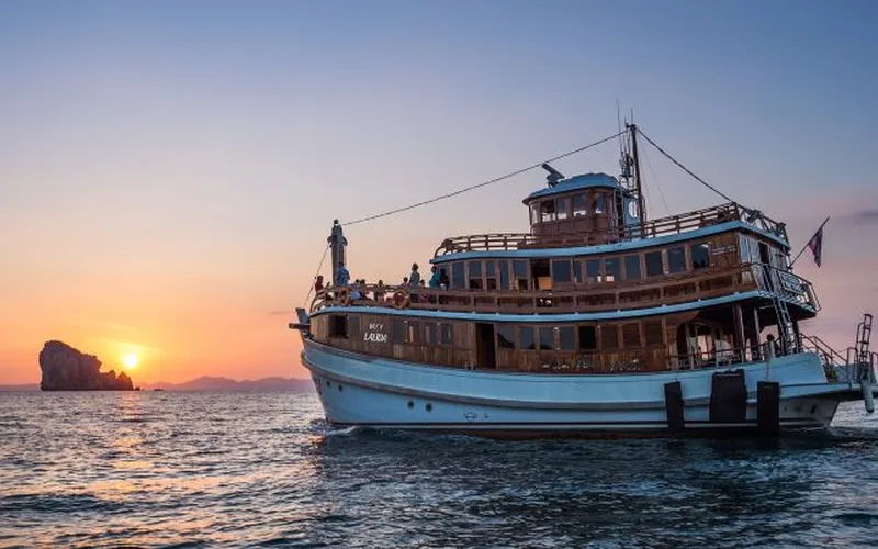 M/Y Lalida golden teak motor yacht at dusk in Krabi