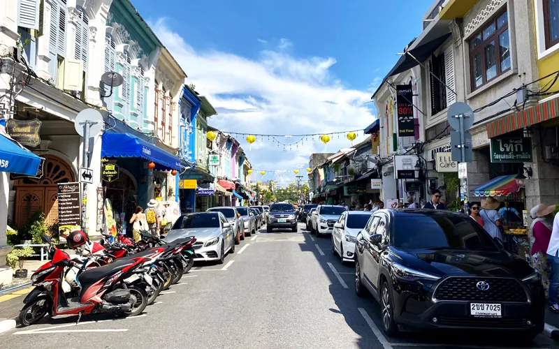 Cars, shophouses and open businesses on Thalang Road on a normal weekday