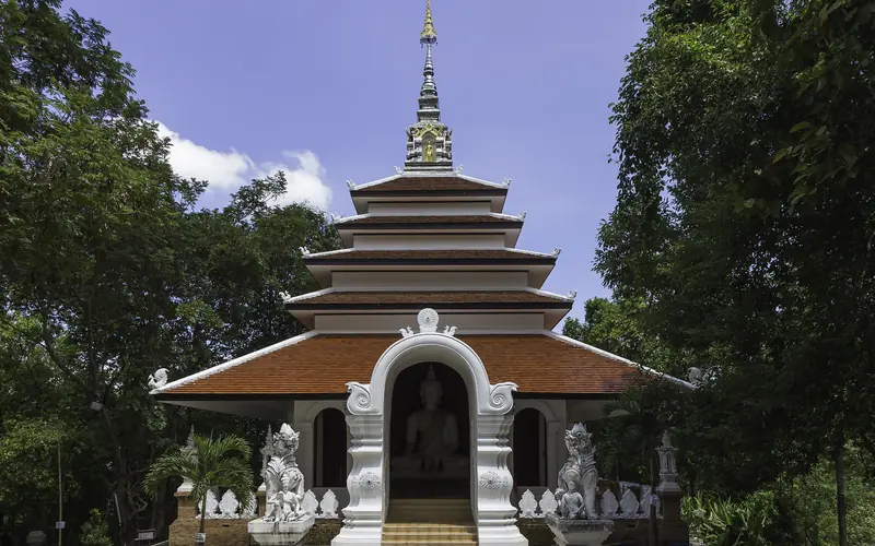 Lanna-style temple building surrounded by forest at Wat Pha Lat