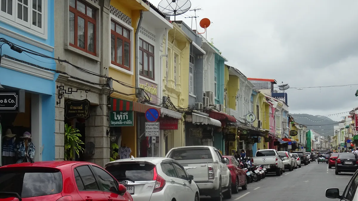 Colourful shophouses and street traffic along Thalang Road in Phuket Old Town